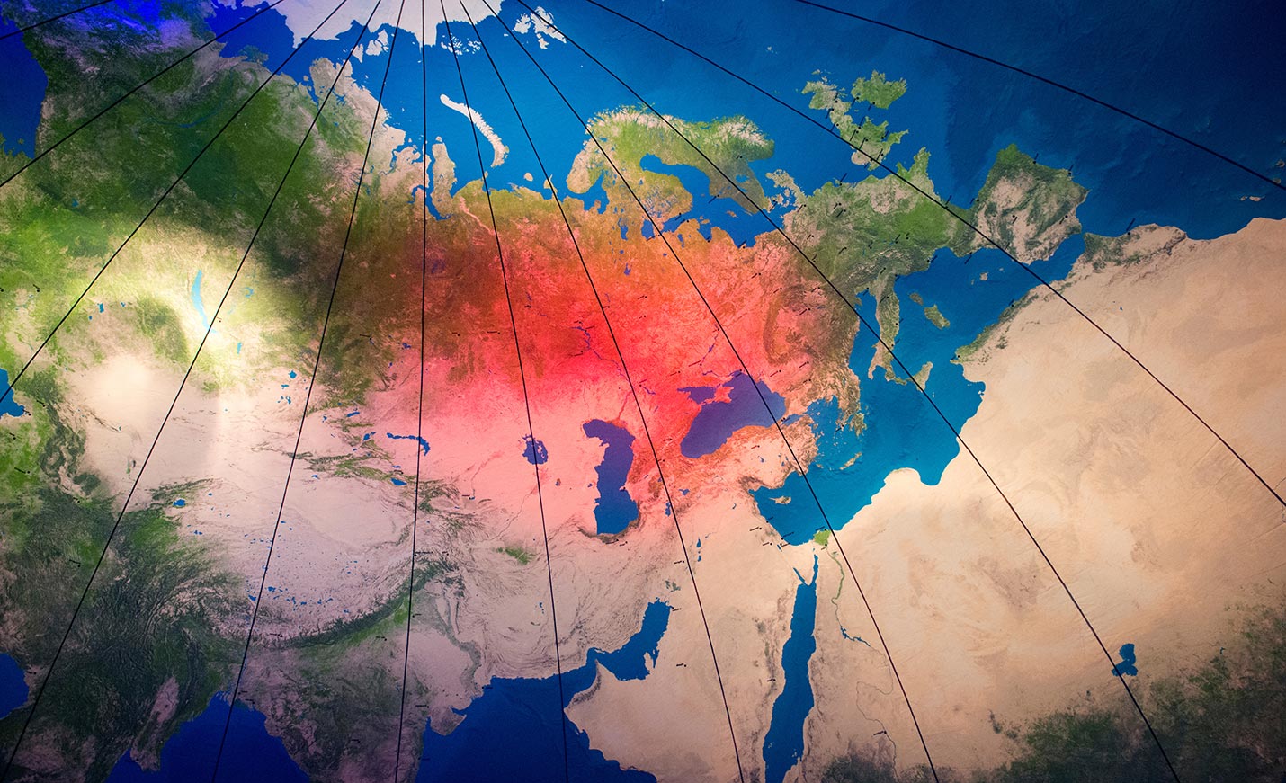 A world map stained with red