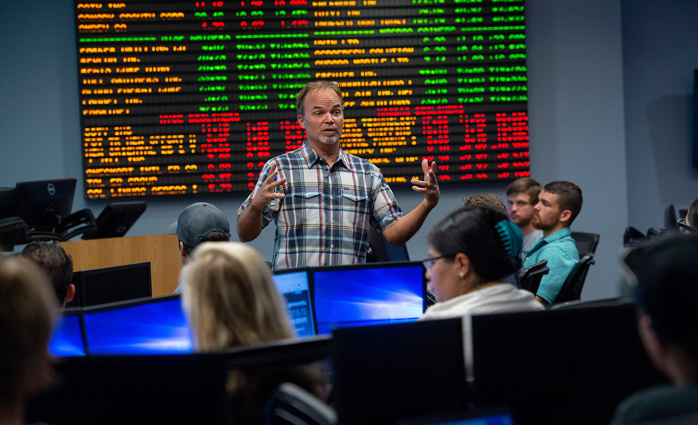 Professor in front of tickerboard